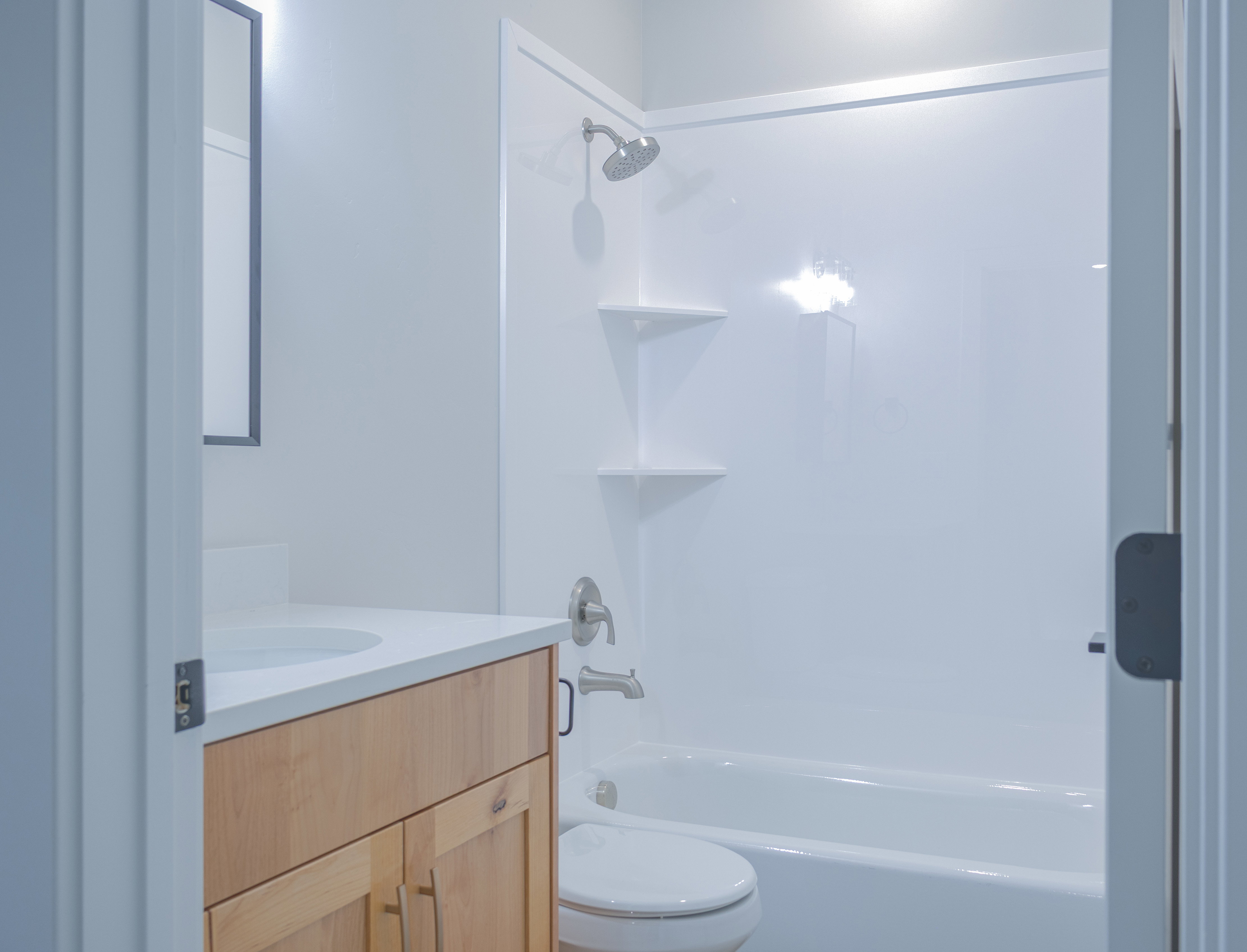 Full bath featuring vanity and washtub / shower combination