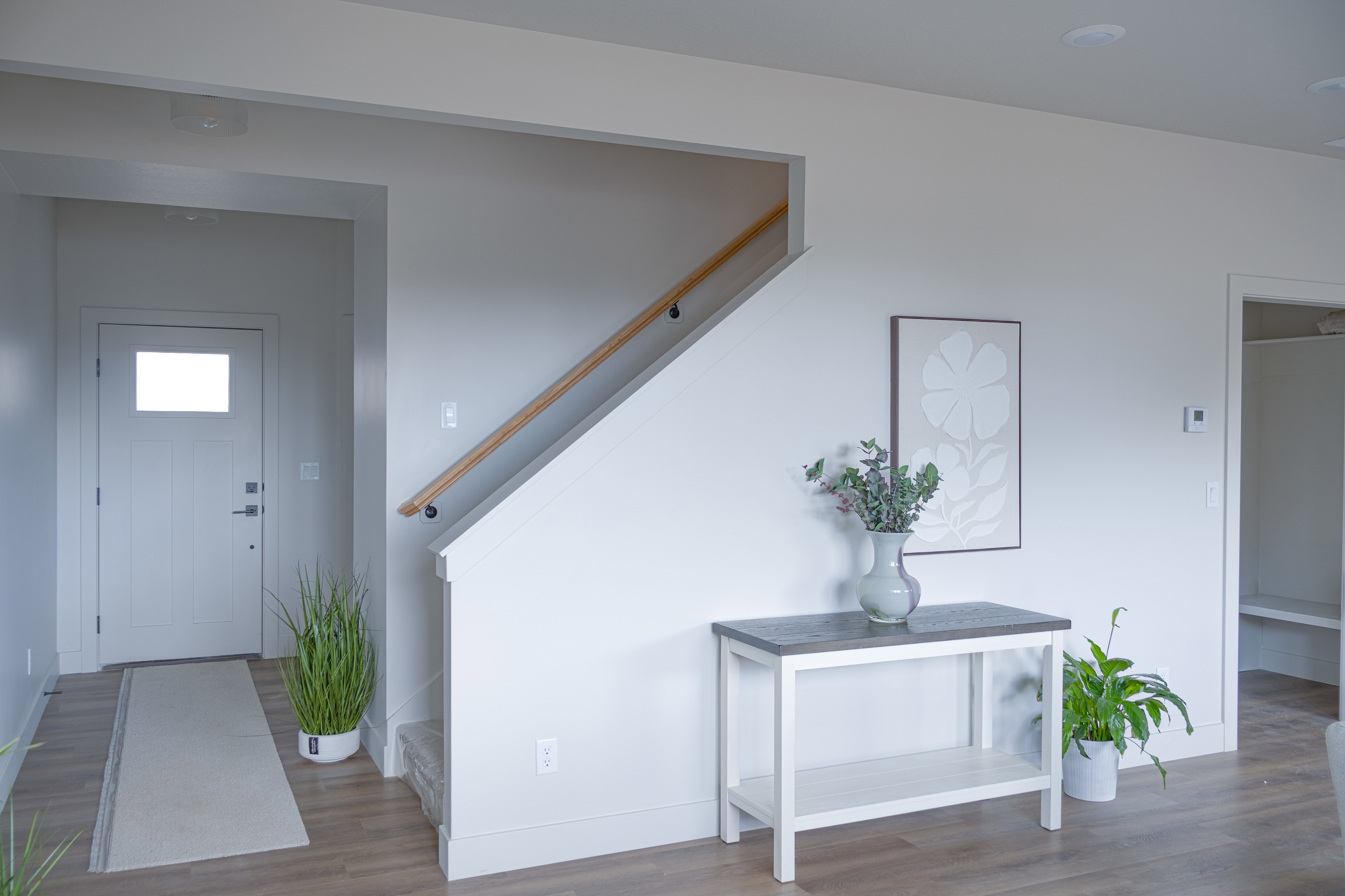 Entrance foyer with stairway and wood finished floors