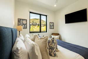 Bedroom with a ceiling fan and recessed lighting
