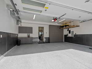 Garage with electric panel and a garage door opener