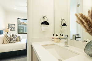 Ensuite bathroom featuring vanity and walk in shower