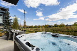 View of pool featuring a hot tub
