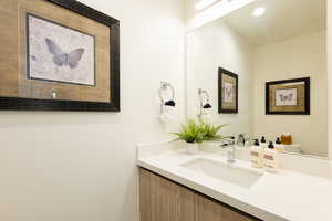 Half bathroom featuring vanity and recessed lighting