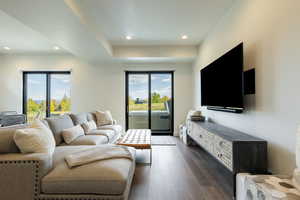 Living area with dark wood-style floors and recessed lighting