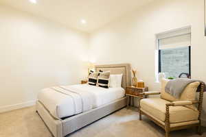 Carpeted bedroom with baseboards and recessed lighting