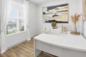Office area featuring light wood finished floors and baseboards