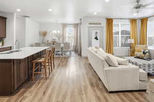 Living room with recessed lighting, light wood-type flooring, and ceiling fan