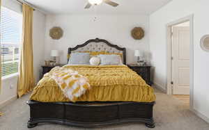 Bedroom featuring carpet flooring, a ceiling fan, wallpapered walls, and an accent wall