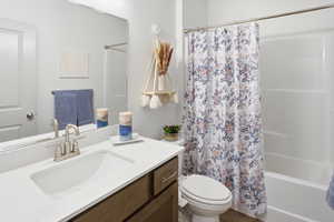 Bathroom with vanity and shower / bath combination with curtain