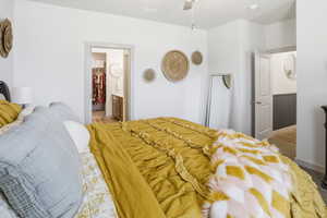 Bedroom featuring connected bathroom and a ceiling fan