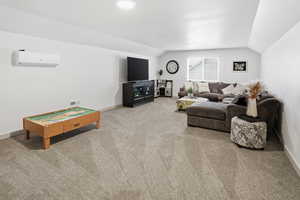 Living room featuring vaulted ceiling and light colored carpet