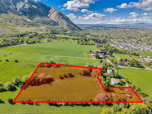 Aerial view of property's location with property parcel outlined and a mountain backdrop