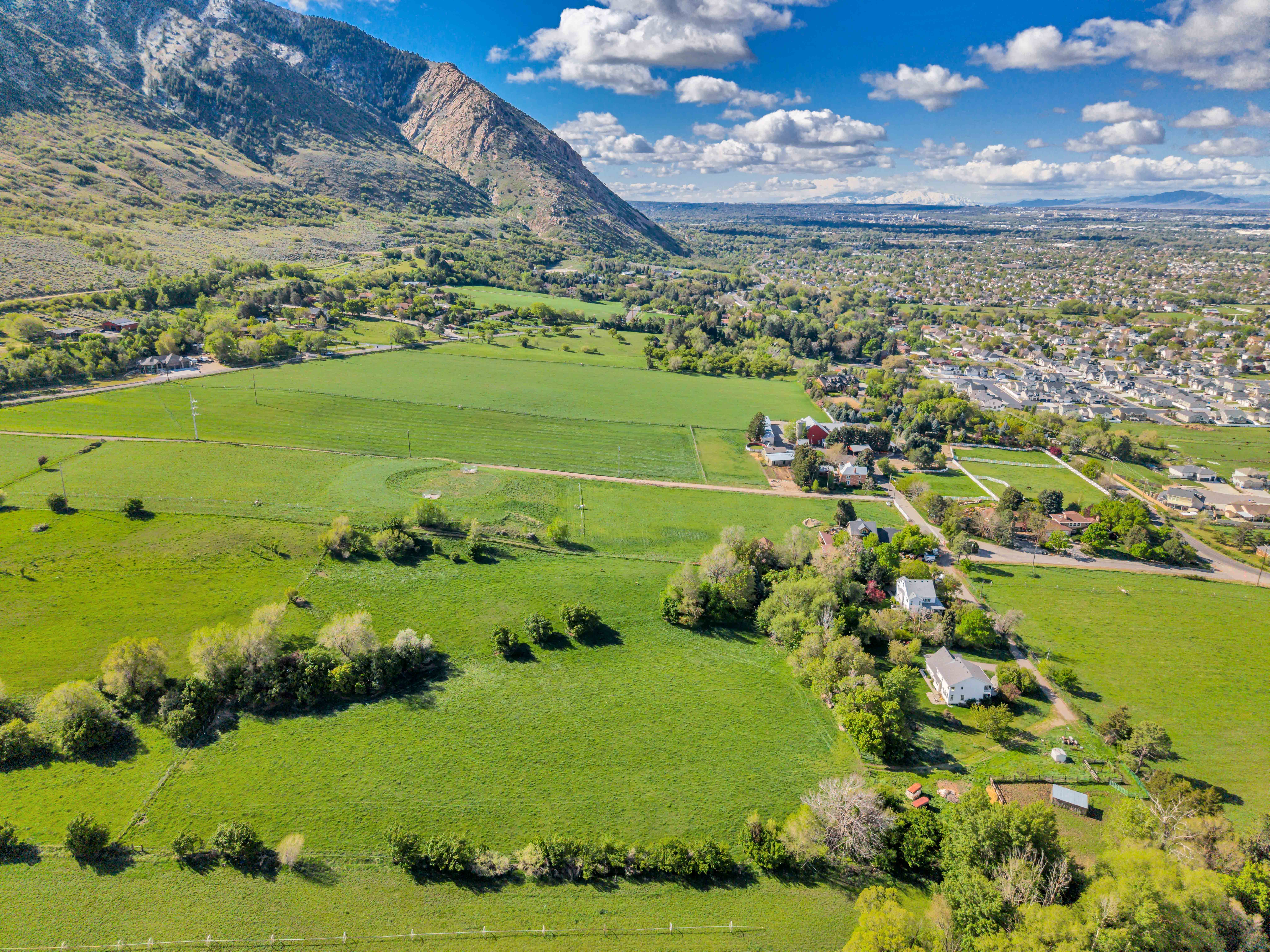 Aerial view of sparsely populated area with mountains and a pastoral area