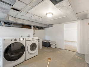 Laundry area featuring unfinished concrete floors and separate washer and dryer