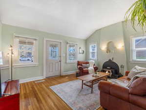 Living area featuring lofted ceiling and wood finished floors