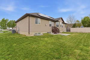 Rear view of property featuring a patio area and solar panels