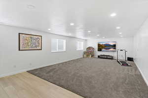 Workout area with wood tiled floors, recessed lighting, and light carpet