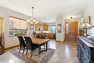 Dining space featuring suspended lighting and light wood-style flooring