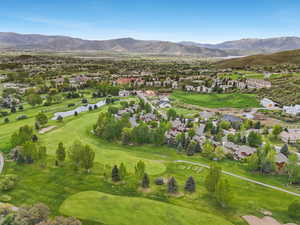 Aerial view of residential area with a local golf course and a water and mountain view