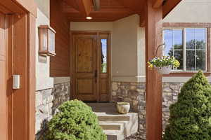 View of exterior entry with stone siding