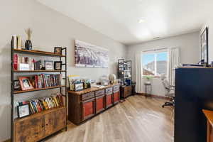 Home office featuring light wood-style floors and baseboards