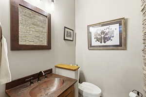 Half bathroom featuring toilet and vanity