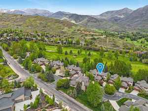 Aerial view of residential area with mountains and a local golf course