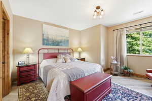 Bedroom featuring baseboards and light wood-type flooring
