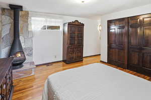Bedroom featuring light wood-style floors, a textured ceiling, and a closet