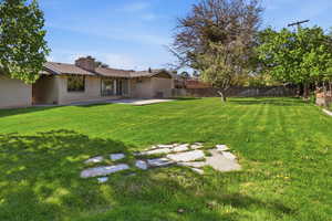 Fenced backyard featuring a patio