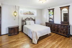 Bedroom with hardwood / wood-style flooring and a textured ceiling