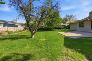 Fenced backyard with a patio
