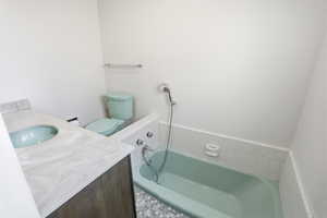 Full bath with vanity and a garden tub