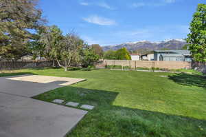 Fenced backyard with a mountain view