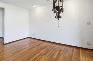 Dining/living room featuring dark wood finished floors and a textured ceiling