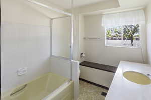 Bathroom with vanity, a tub, light flooring, and a shower