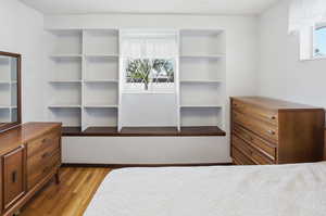 Bedroom featuring multiple windows and light wood-type flooring