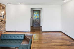 Spare room featuring a textured ceiling and dark wood-style flooring