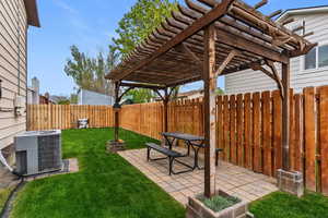 Fenced backyard with a patio area and a pergola