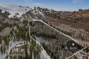 Aerial view of property and surrounding area with a mountain backdrop and property parcel outlined