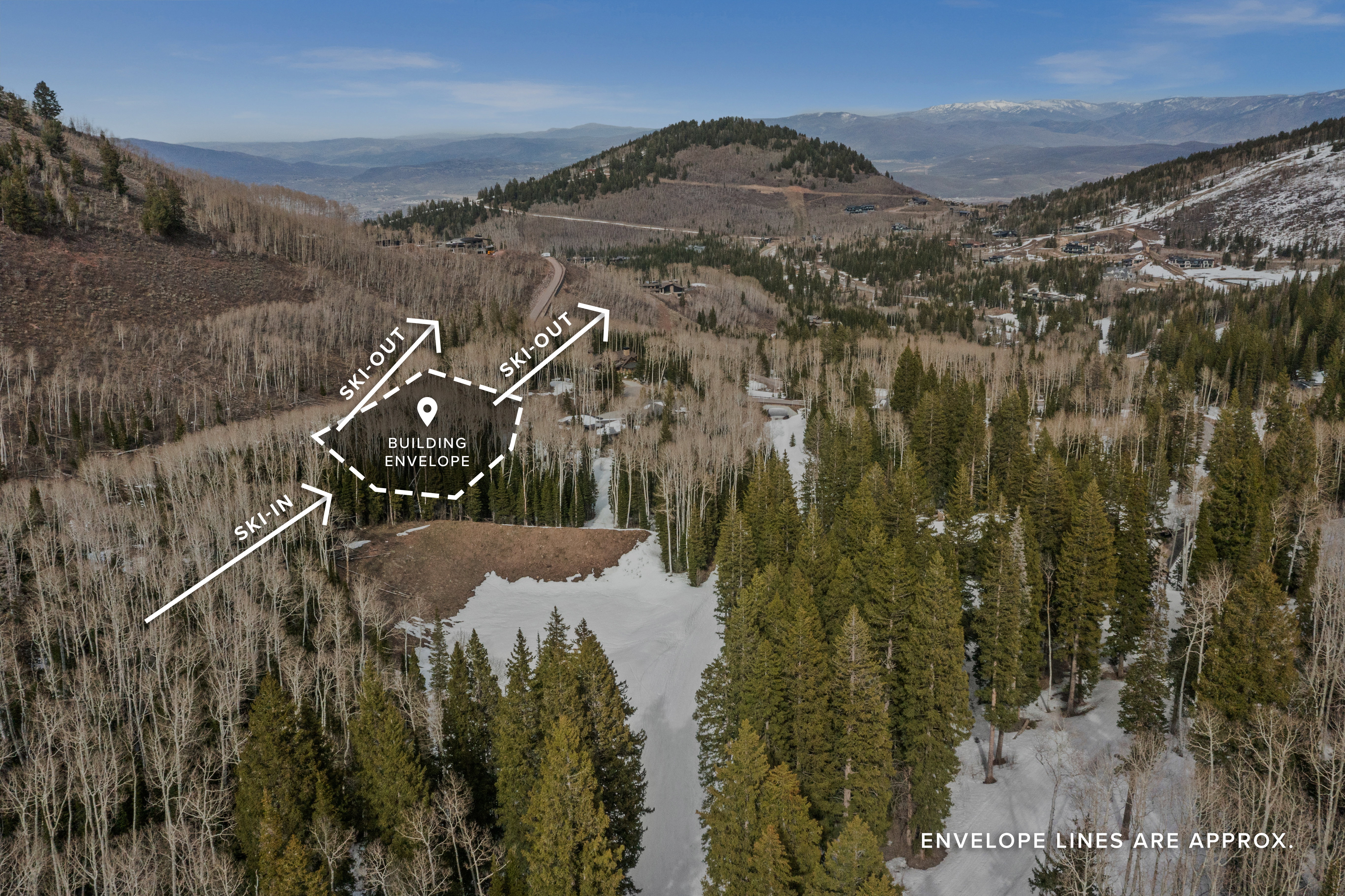 Aerial view of property and surrounding area featuring a mountain backdrop and property boundaries highlighted