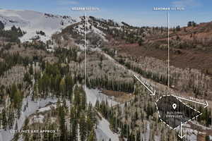 Aerial view of property and surrounding area featuring a mountainous background and property parcel outlined