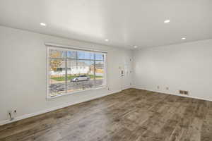 Unfurnished room with recessed lighting and dark wood-style floors