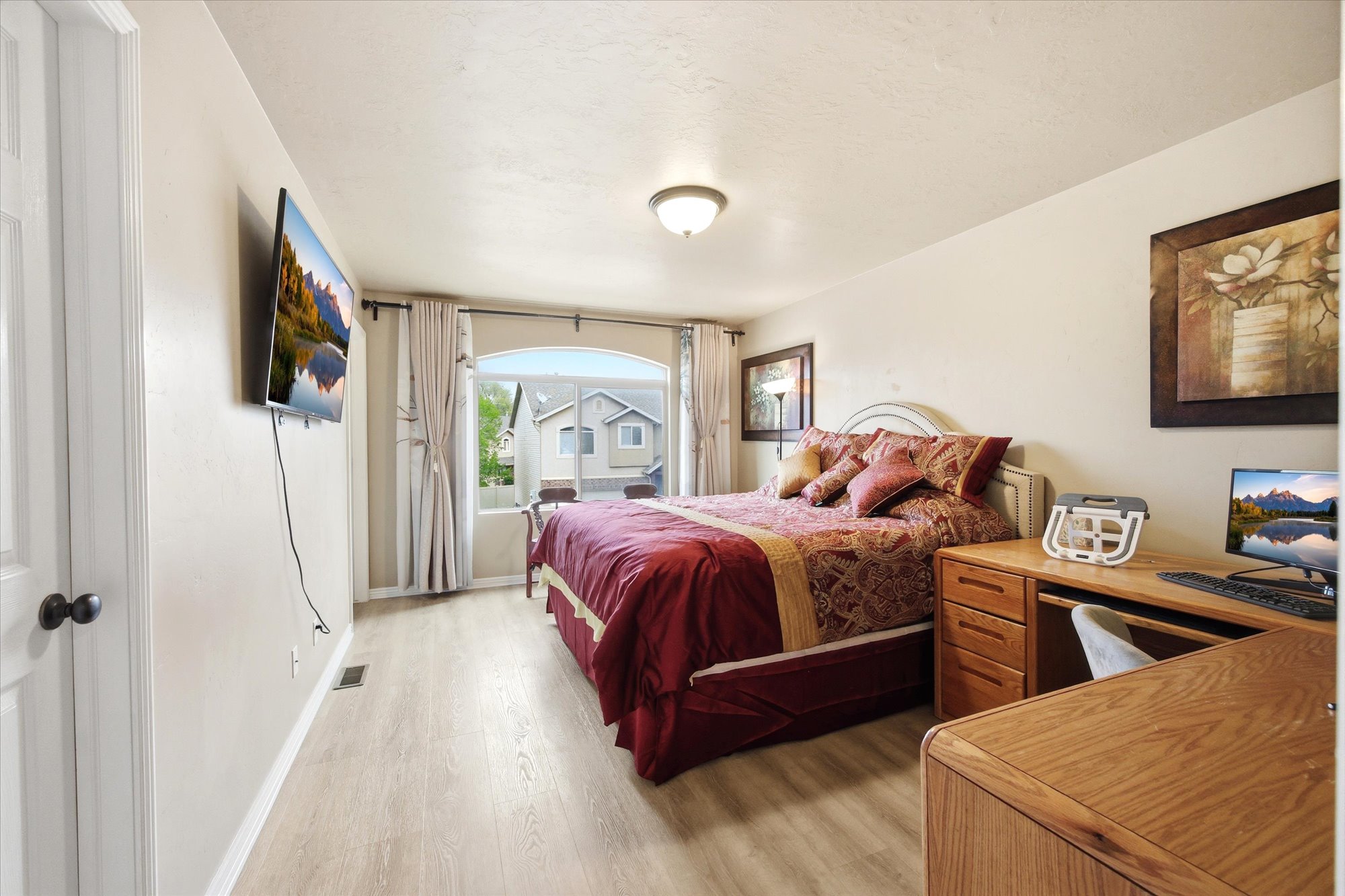 Bedroom with light wood-style floors and baseboards