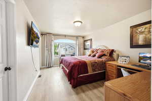Bedroom with light wood-style floors and baseboards