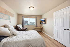 Bedroom with baseboards and light wood-style floors