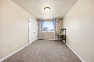 Unfurnished bedroom featuring baseboards and light colored carpet