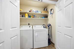 Laundry area featuring washer and dryer and baseboards