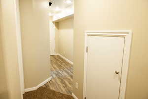 Corridor with baseboards and light wood-style flooring