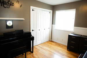 Office area featuring light wood-style flooring and baseboards